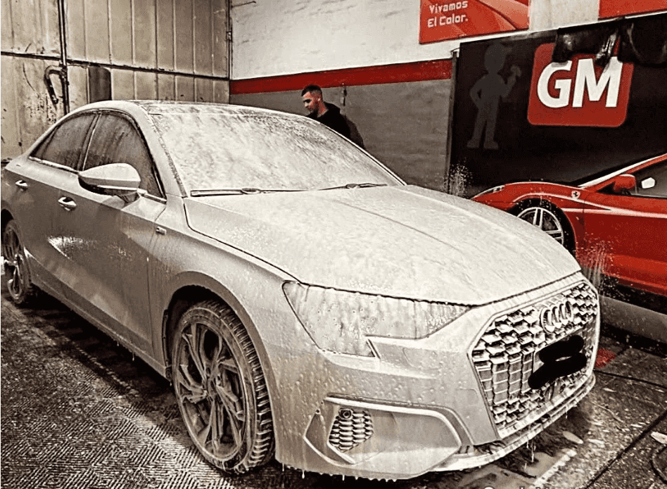 Audi plateado cubierto de espuma durante el lavado detallado en el taller